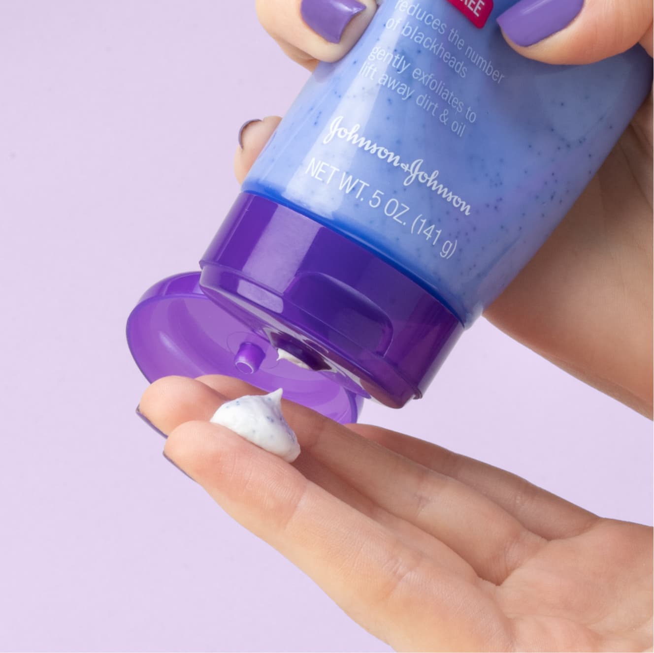 White blob of Clean & Clear blackhead eraser applied by hand with purple nail polish