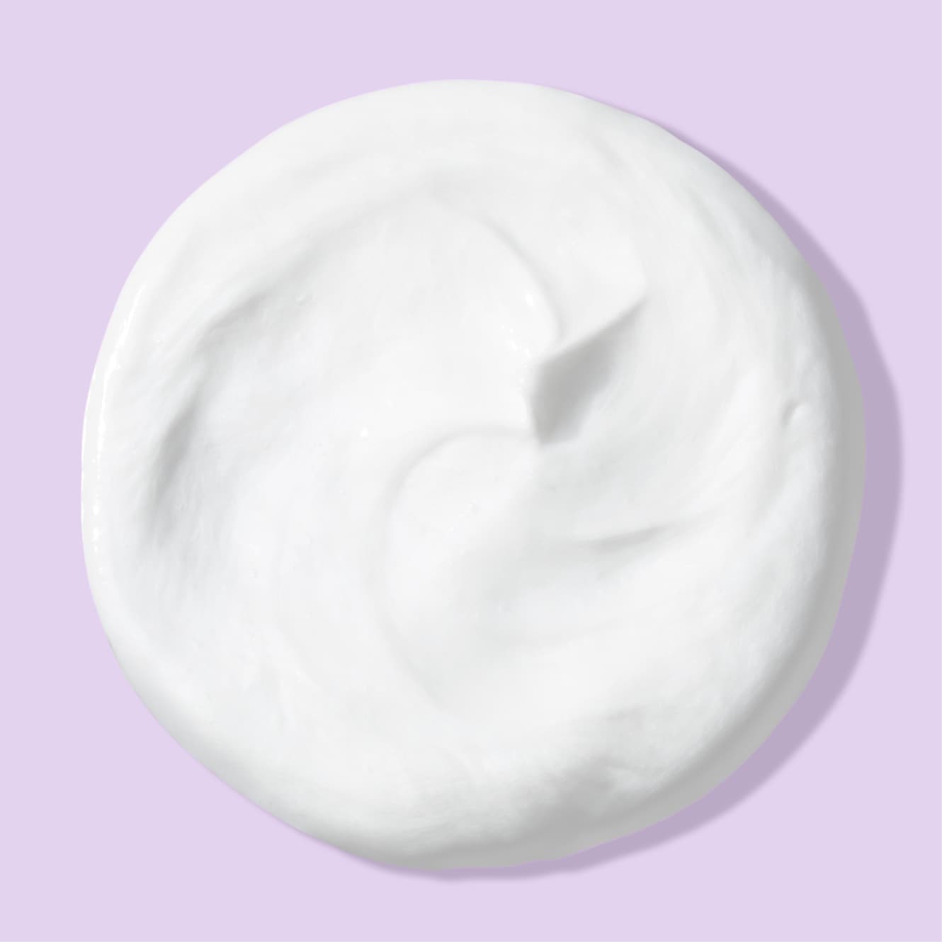 White blob of deep action cream cleanser for sensitive skin over light purple background
