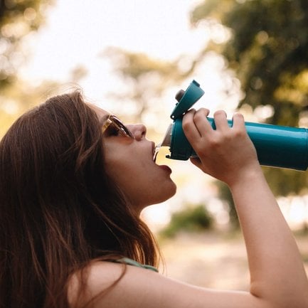 Woman drinking water from a water bottle