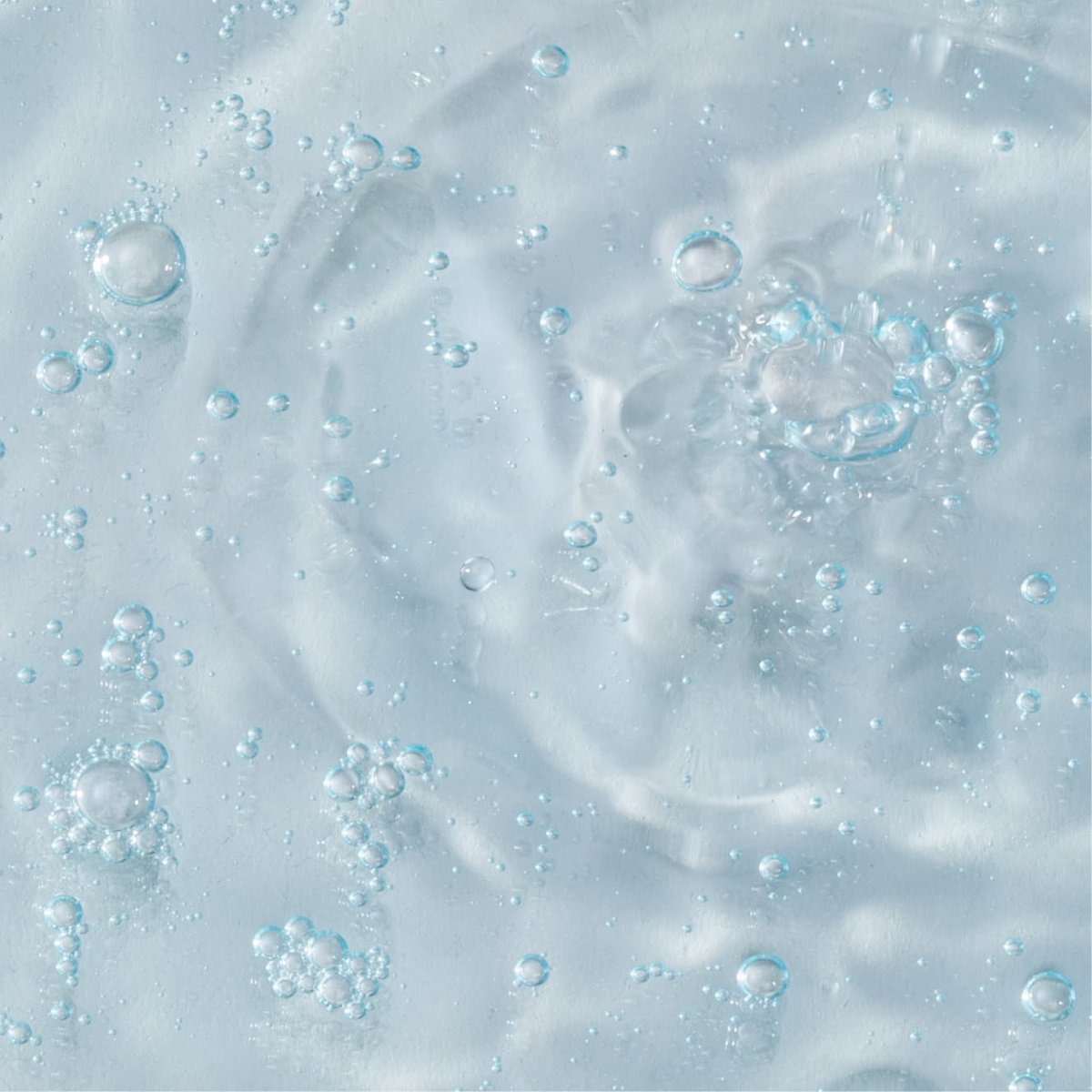 Close up of blue deep cleaning toner for sensitive skin liquid with bubbles 