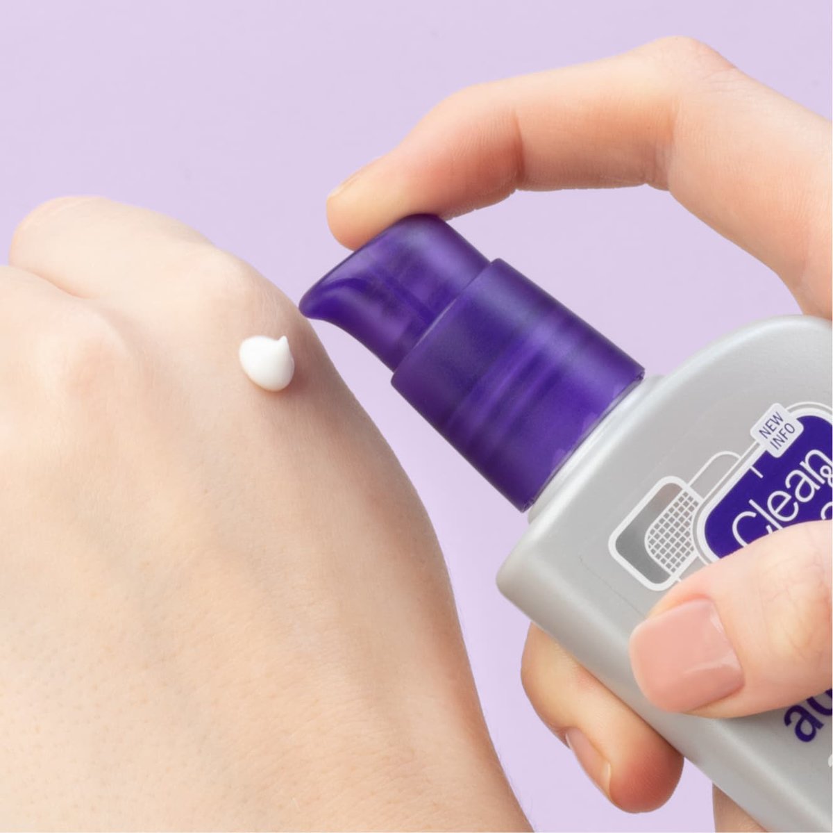Clean & Clear Advantage oil free moisturizer applied to back of fist in front of light purple background