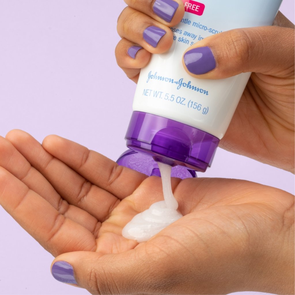 White Clean & Clear daily pore cleanser squeezed onto hand with purple nail polish