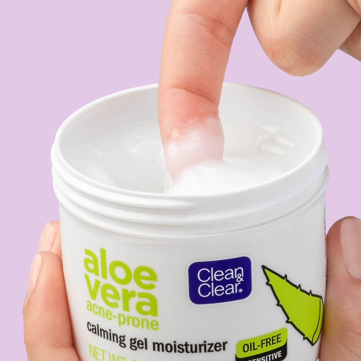 Clean hand holding jar with finger dipping into the gel moisturizer