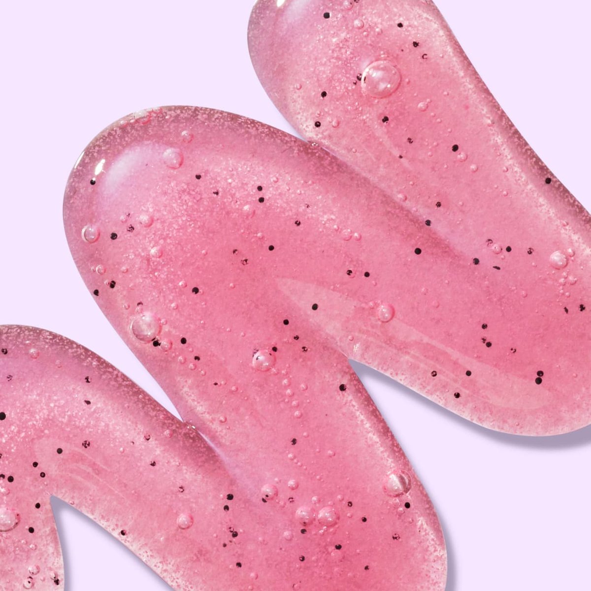 Bright pink gel with black beads and bubbles in front of light pink background