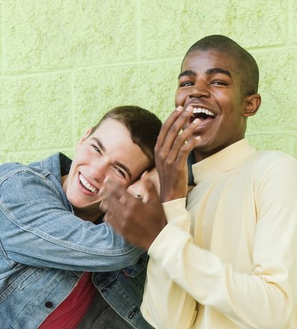 Two Men holding hands and laughing
