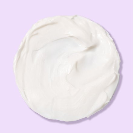 Circle of white Advantage Acne Control cream over light purple background