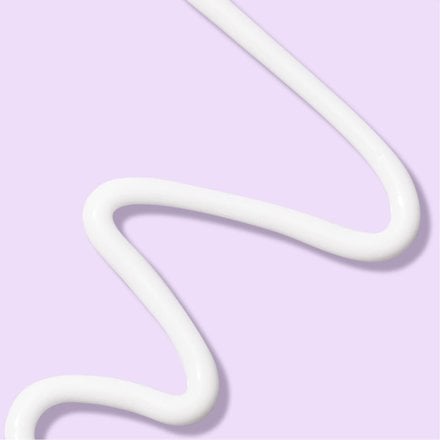 White paste squiggle of Advantage Acne Control skincare in front of a light purple background
