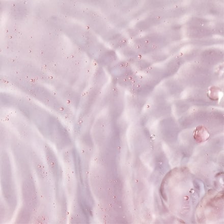Pink underwater with ripples and bubbles